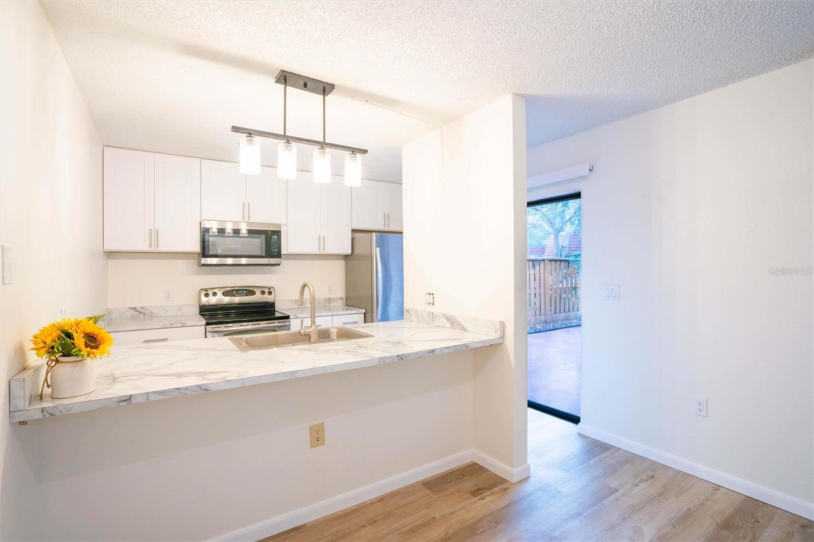 Open renovated kitchen with new island and open to sliders.