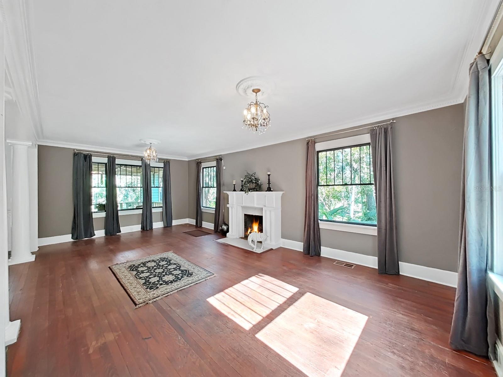 Gorgeous large living room with wood burning fireplace.