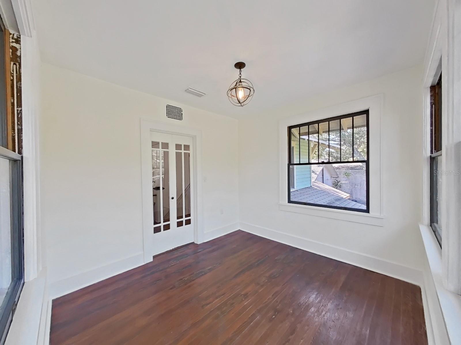 This room extends over the large front porch with windows on 3 sides and French doors.  Perfect for office or den