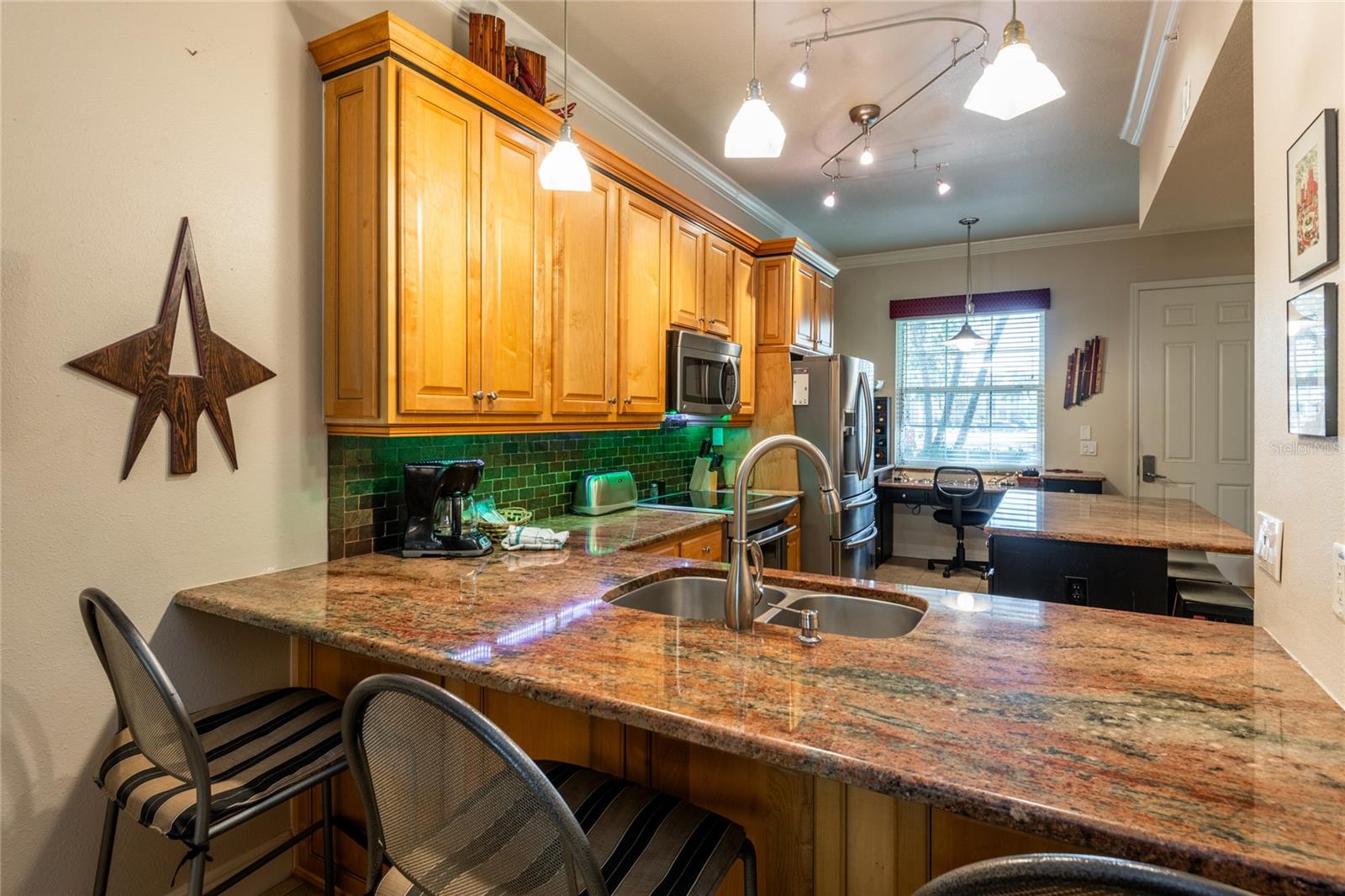 Breakfast bar can seat either 3 large stools or 4 smaller ones.  Under counter lighting