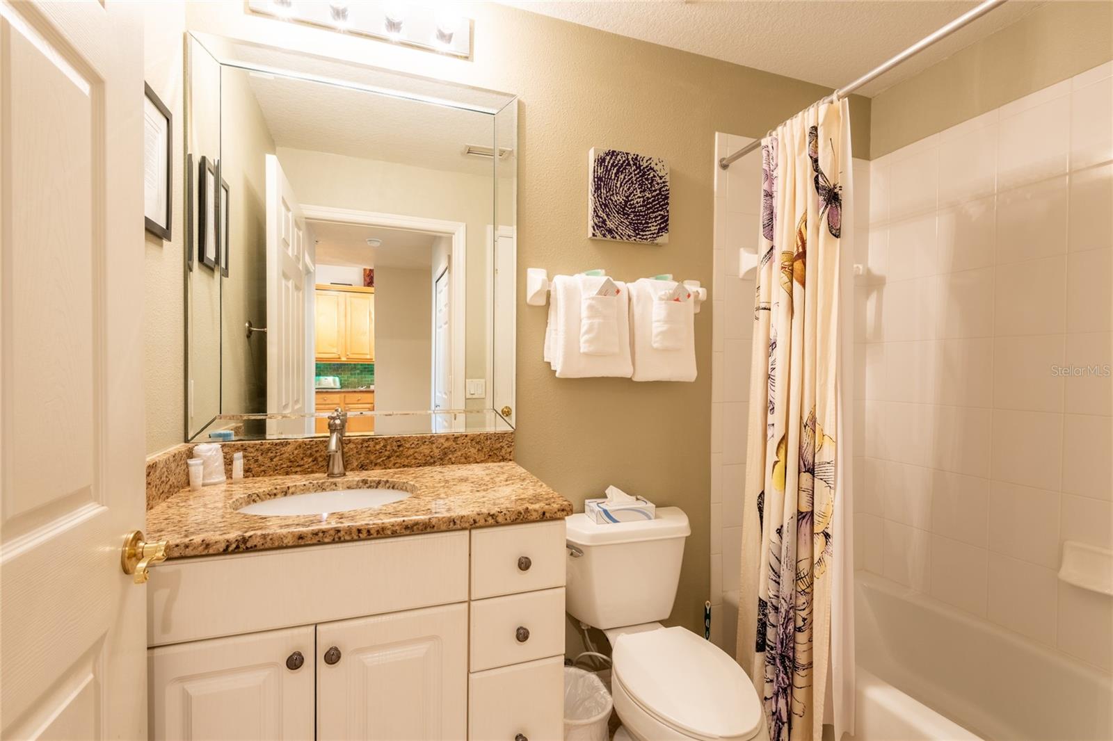 Guest bathroom with tub/shower and high vanity.