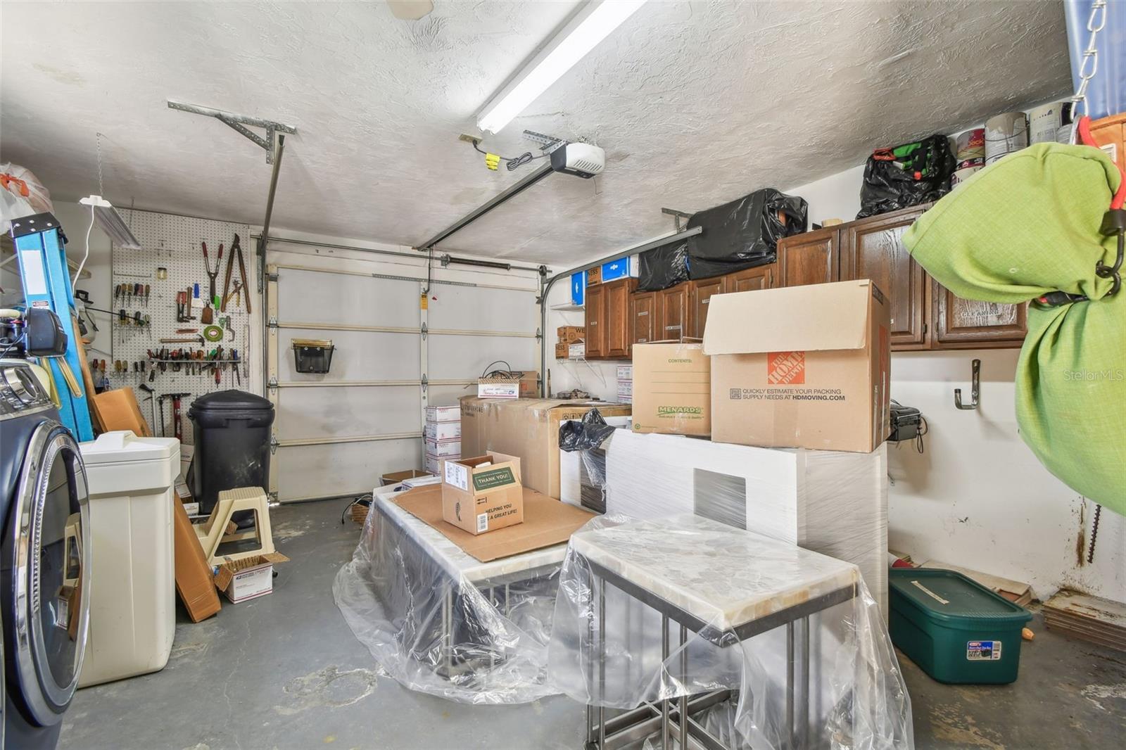 Garage with washer/dryer hook-up, garage door opener and storage