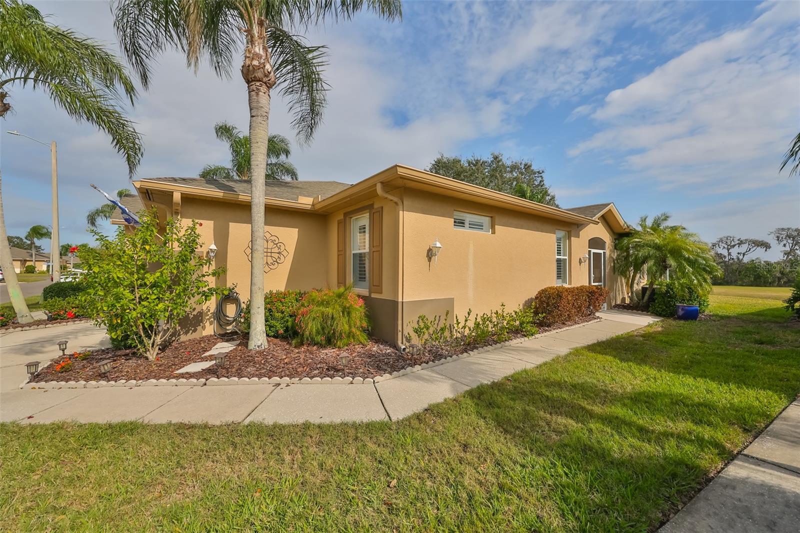 As you walk up to this enchanting move in ready Villa, notice the side entrance walkway for easy access.