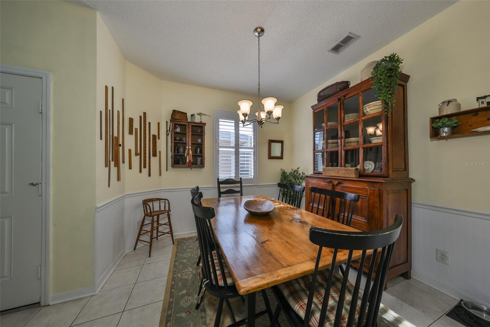 Notice the curved Architectural features in the wall, bead board and chair rail.  The plantation shutters allow plenty of natural lighting.