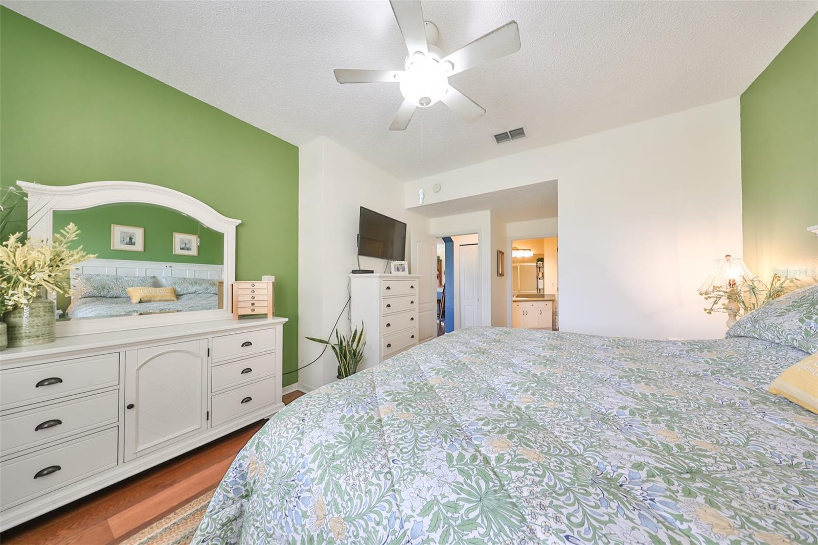 Primary Bedroom has lots of space and also a ceiling fan with lighting for added brightness.