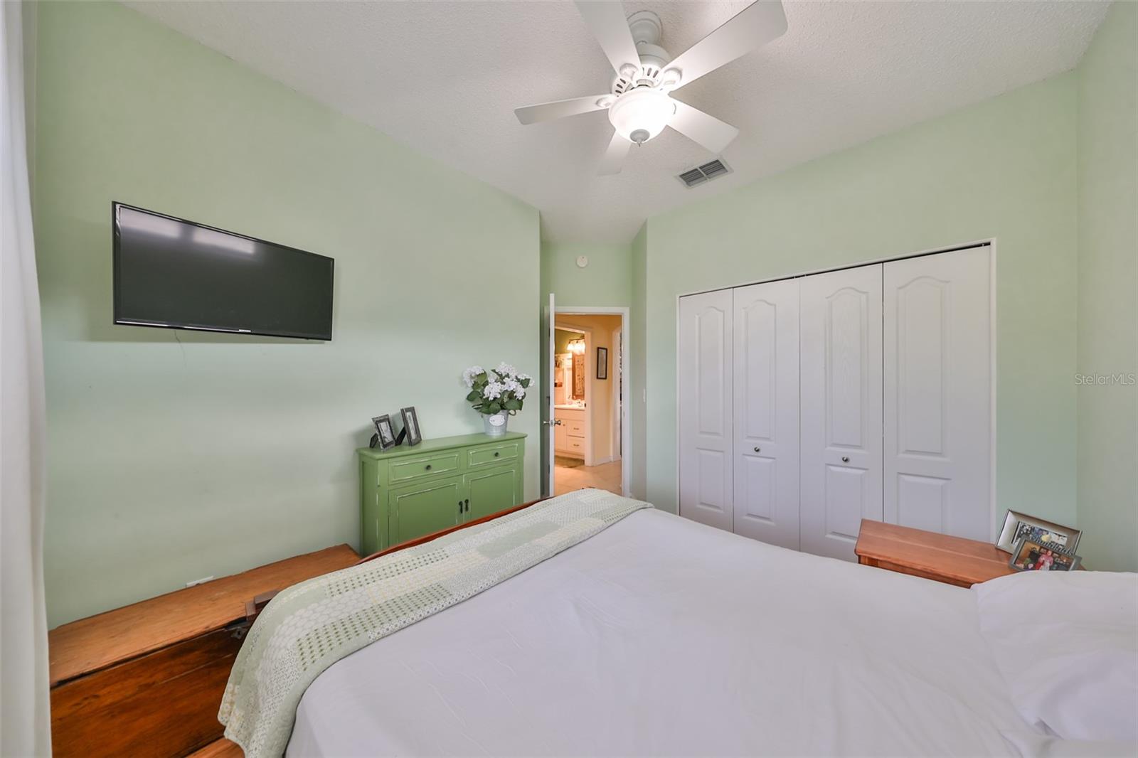 This bedroom has a double closet, which provides extra storage space. The closet is located in the corner of the room, and has a built-in shelf.