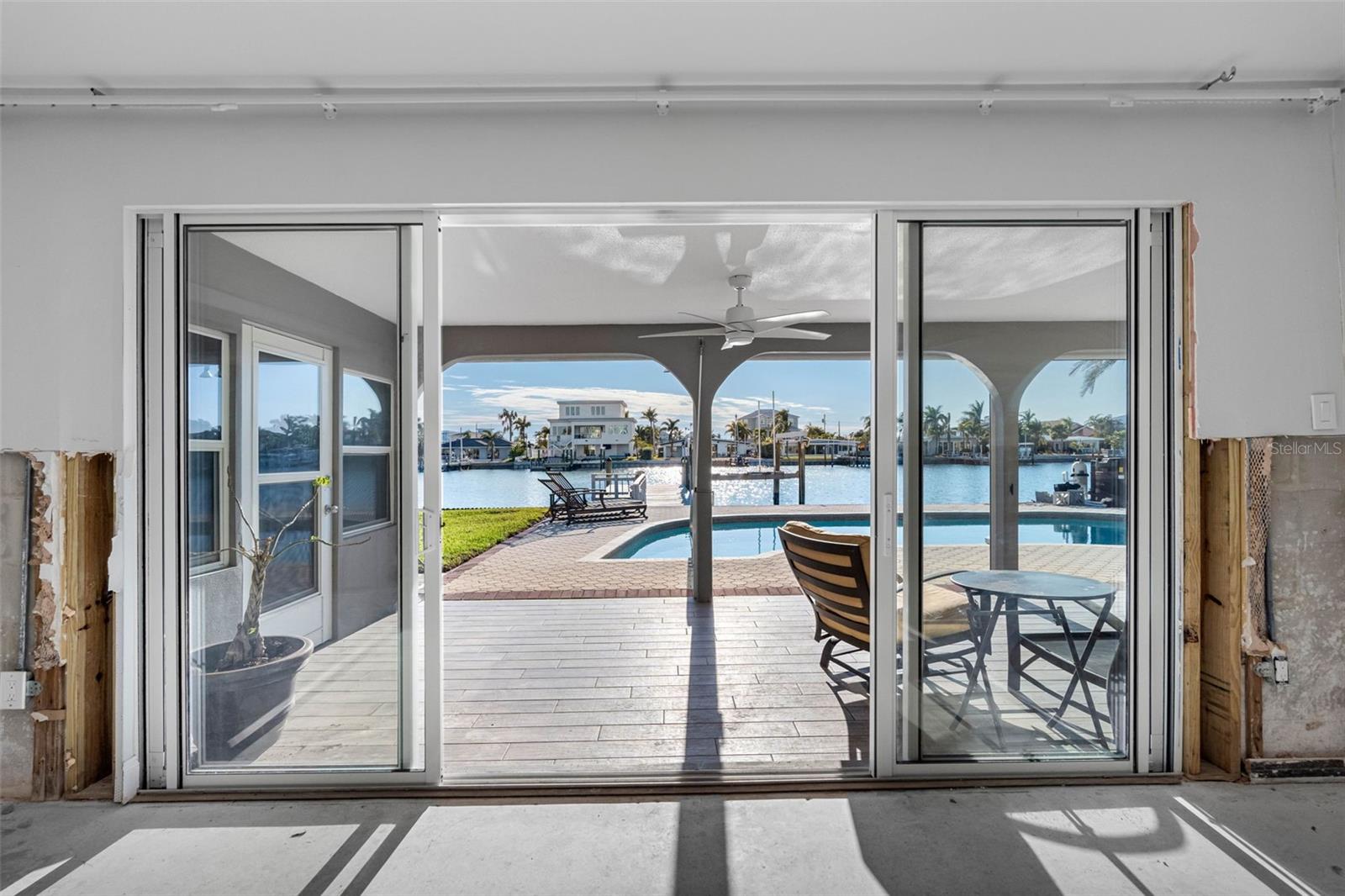 Sliders open to covered lanai with ceramic pavers.