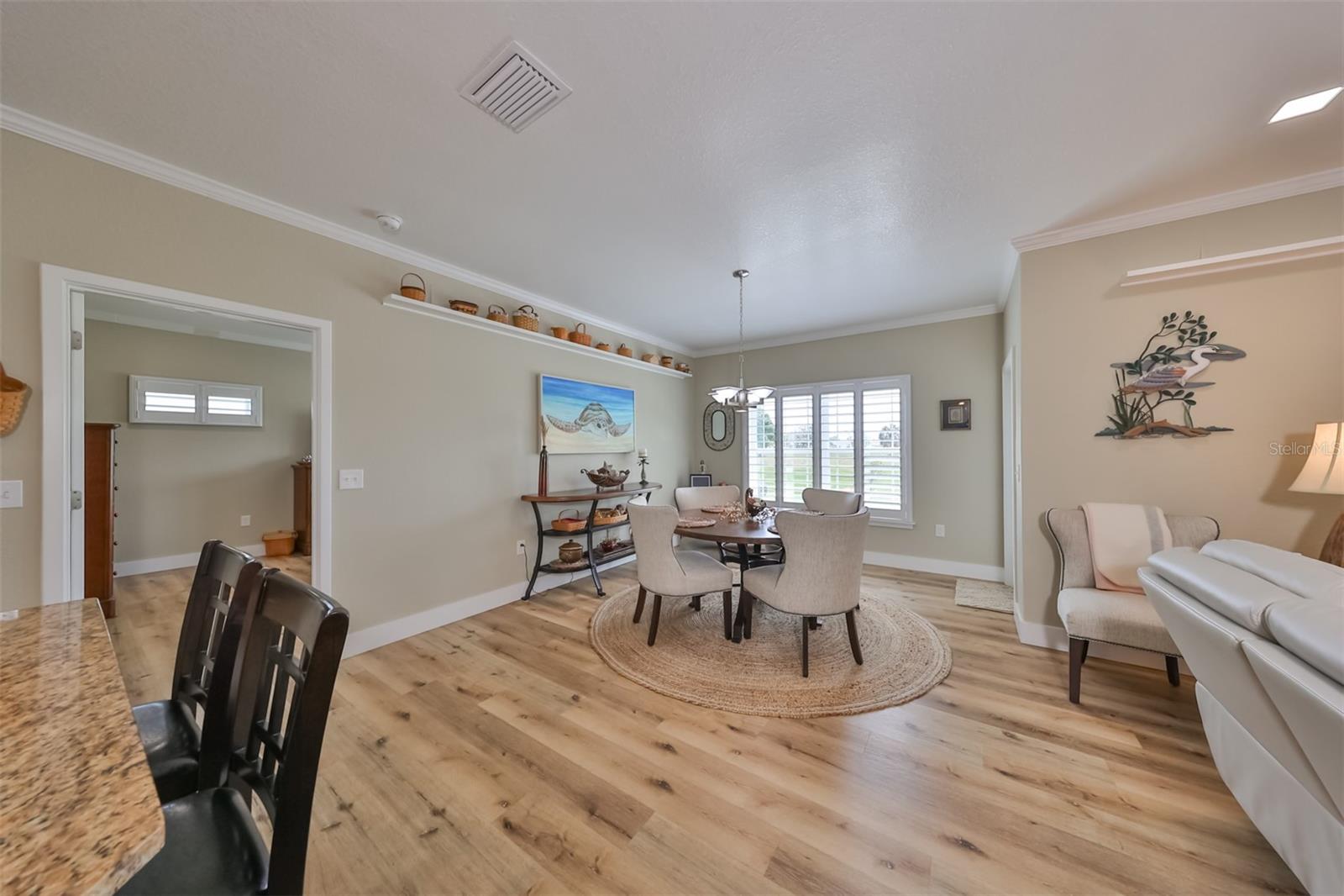 The dining/living/kitchen room combo includes lots of additional lighting from the extra windows that overlook the backyard and greenbelt.