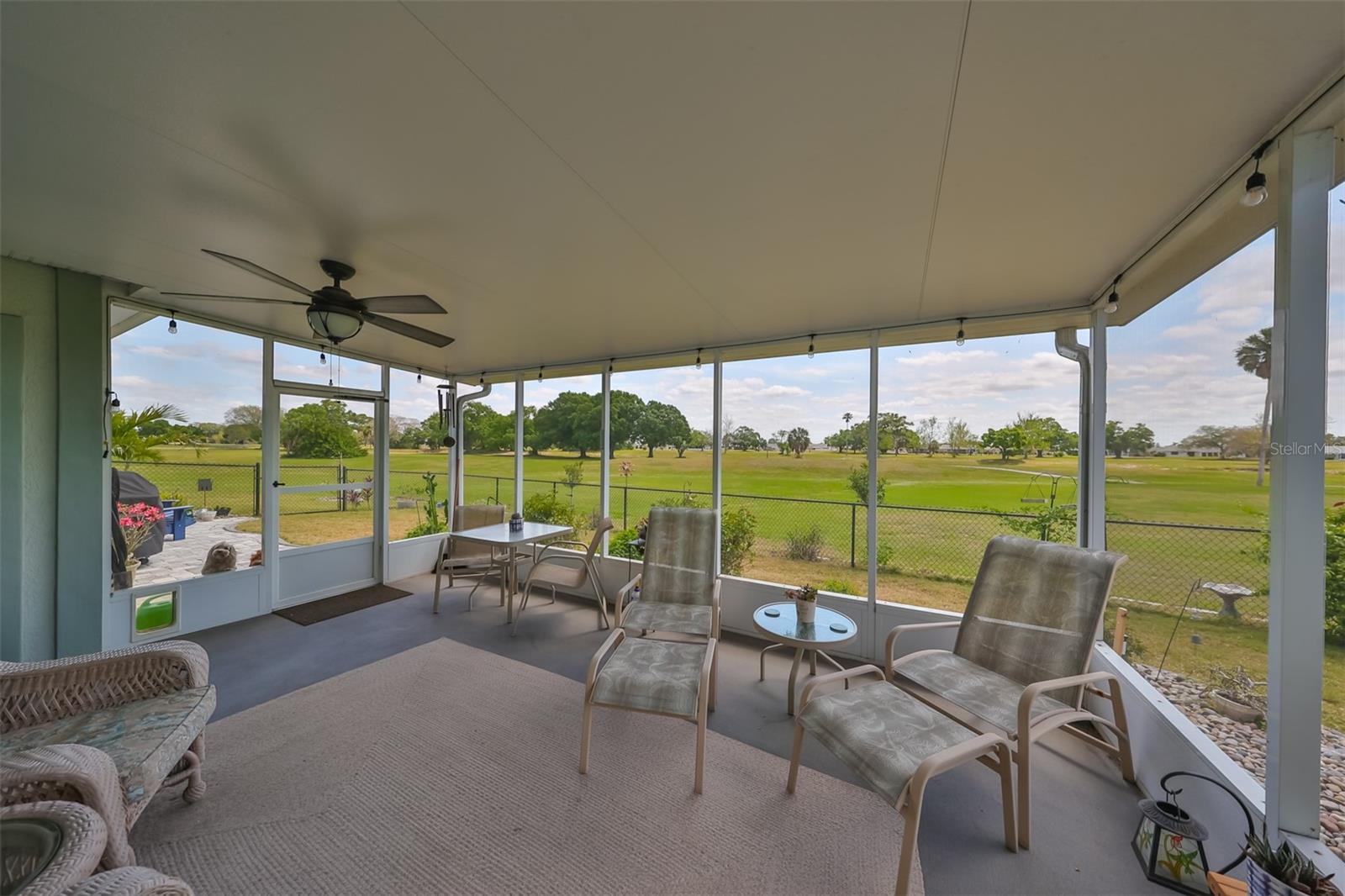 Large back patio with ceiling fan and lighting, covered and enclosed and large enough to comfortably fit in patio furniture for relaxing all year round in as you overlook the GREENBELT. There is an open-air patio for grilling or enjoying the sun.