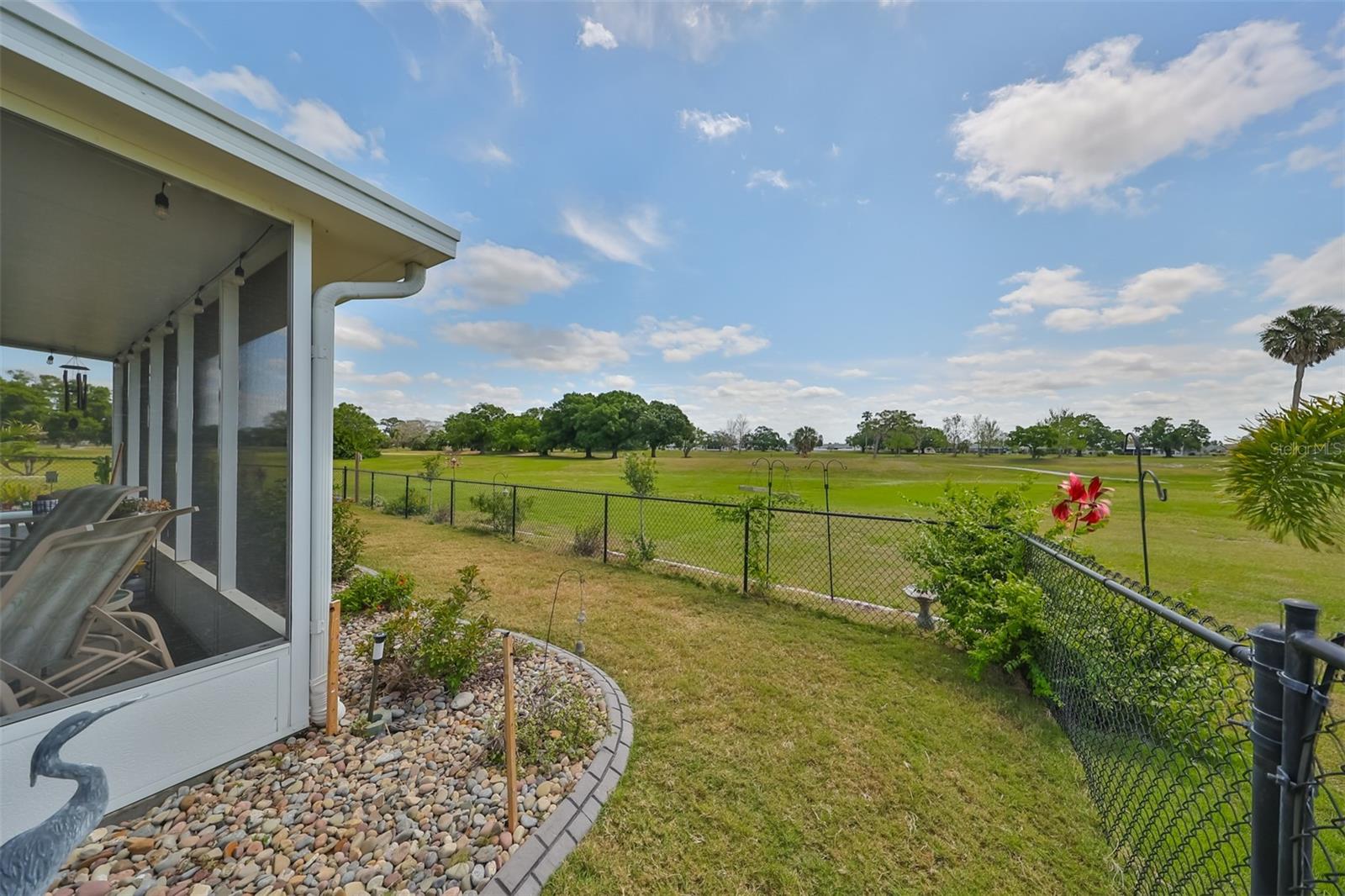 Fenced in backyard landscaped with custom rock and has been recently resodded.