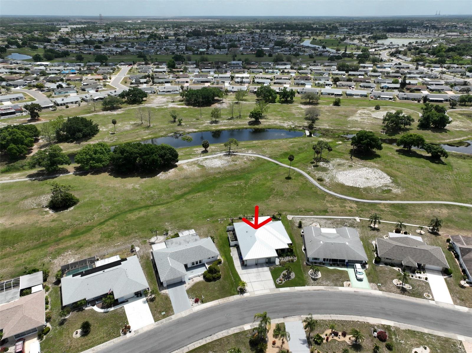 Ariel view of home, outlined with a red arrow.