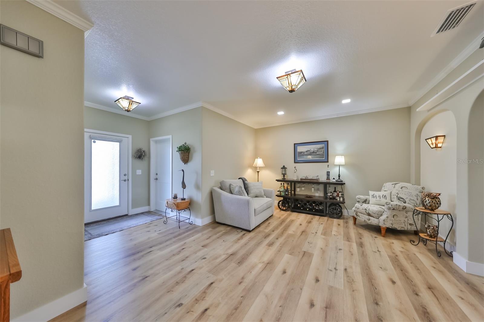 As you walk into this home, you immediately enter into the front foyer/den. Perfect for an additional seating area, library, MUSIC area or wet bar.