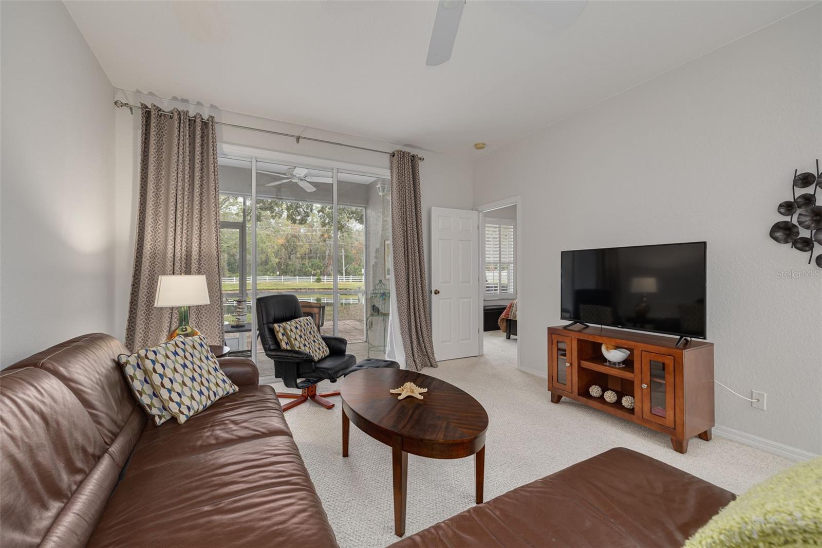 Spacious living area overlooks the lanai and pond!