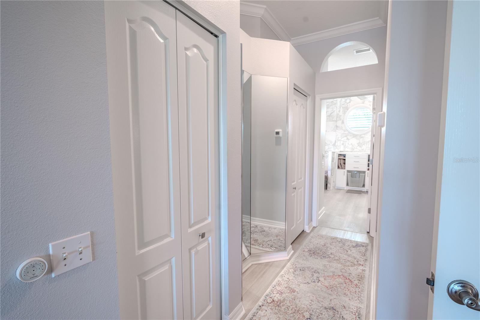 The primary bedroom and ensuite features a custom walk-in closet with (drawers/shelves/hanging space)