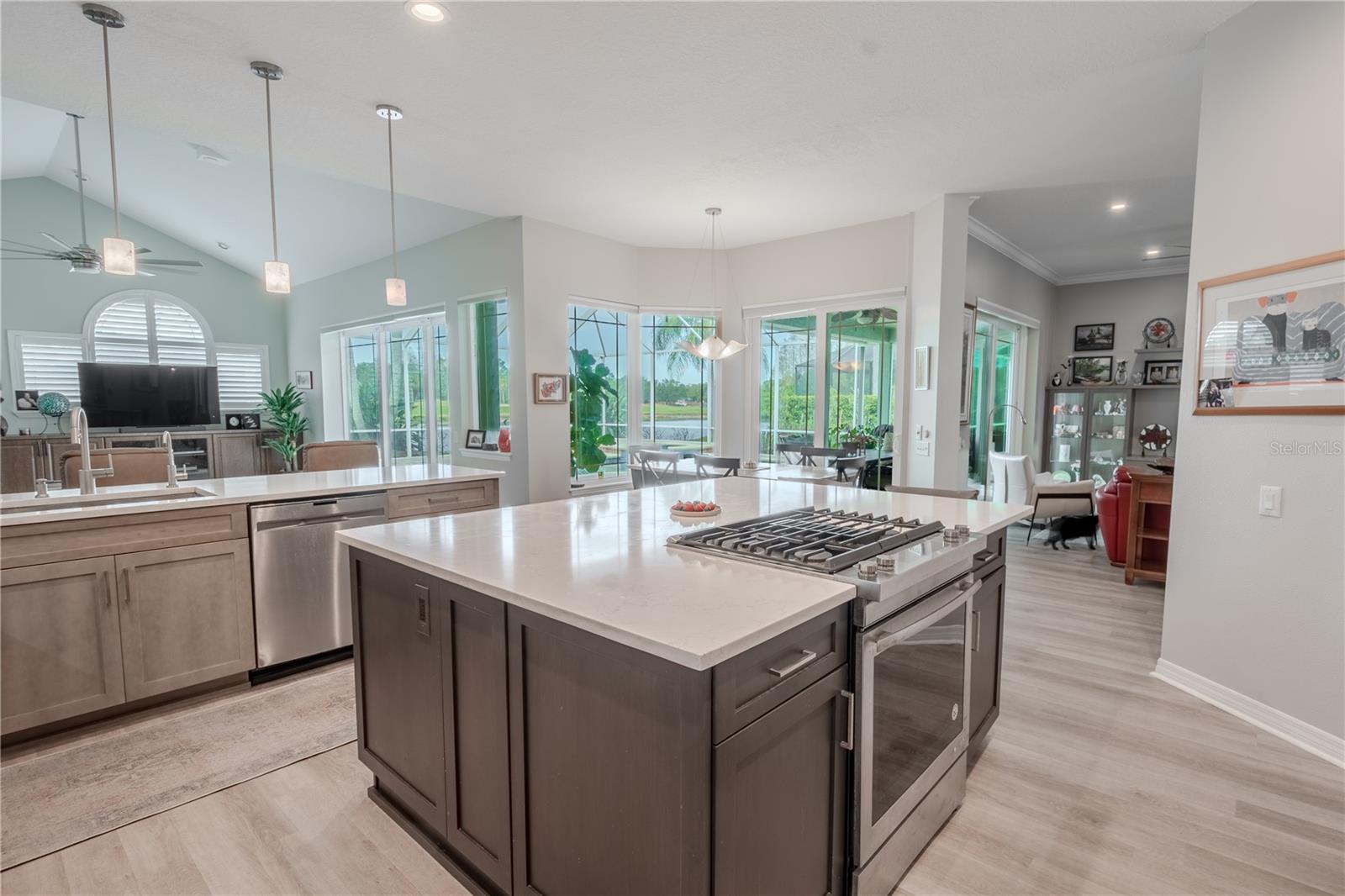 The kitchen island features a gas range and oven, plenty of storage and seating.