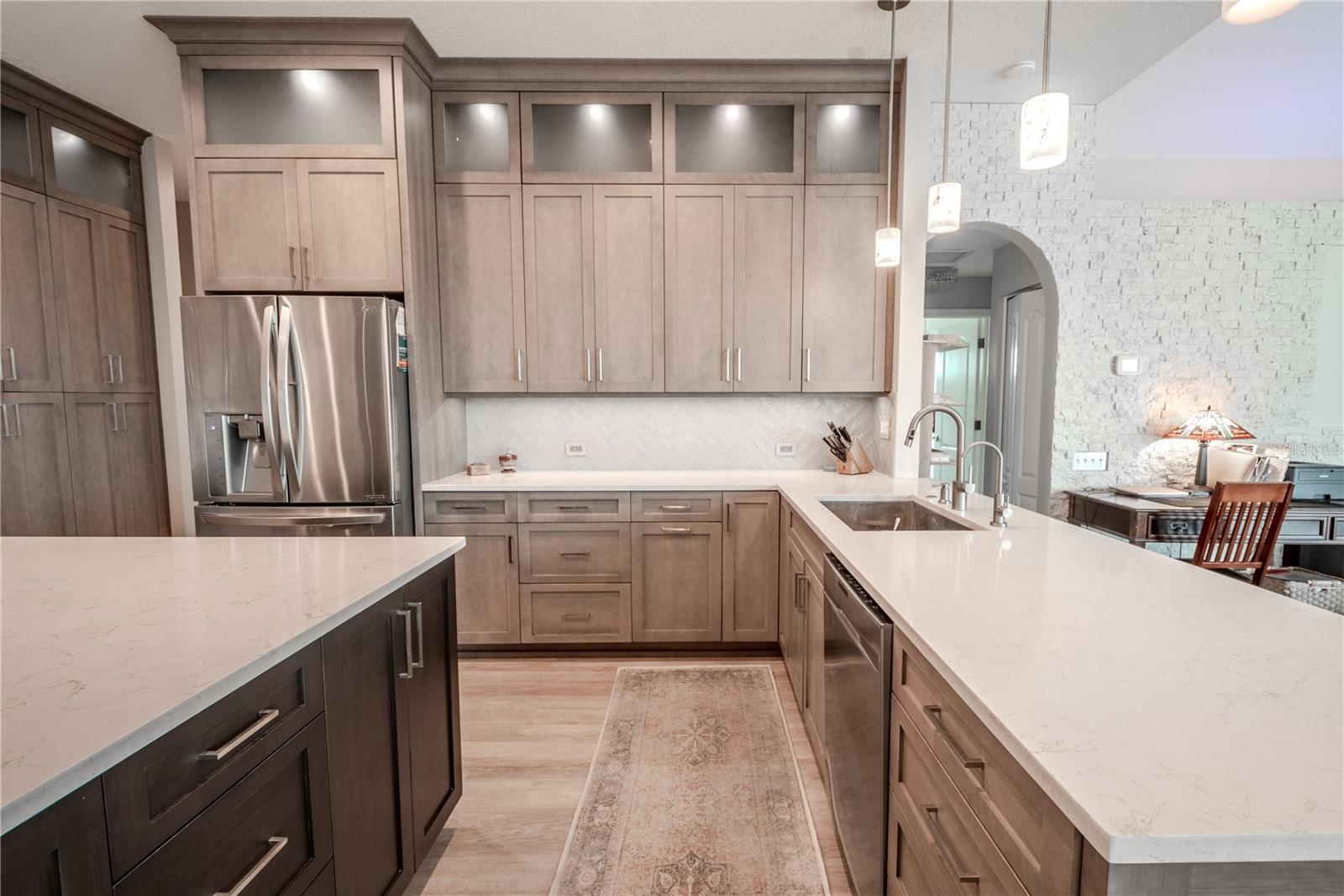 This kitchen is a cooks delight with an abundance of counter space for prep and cabinet and storage for all of your kitchen appliances, keeping counters sleek and clutter free!