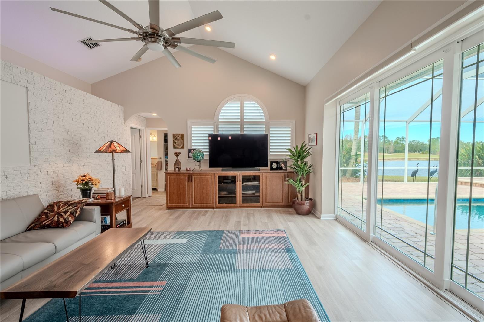 Family room featuring Programmable window shades facing pool area