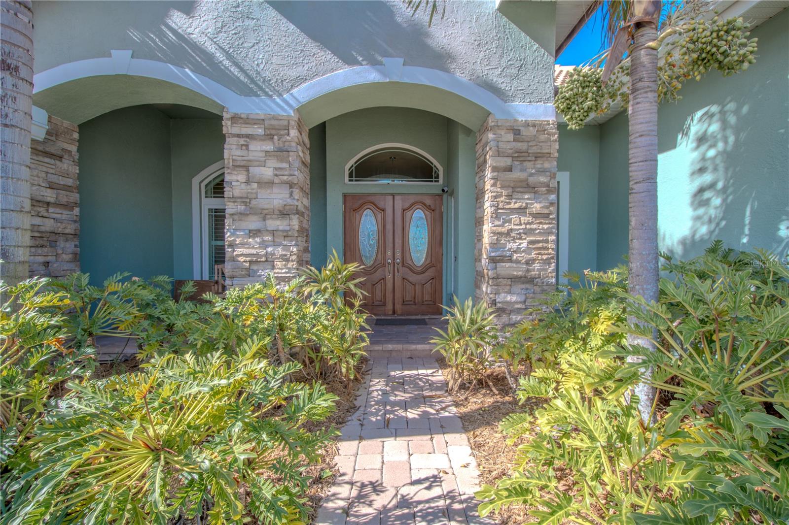 Welcoming covered entry and front porch with front double doors.