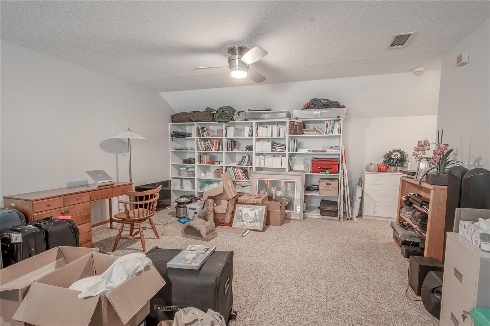 This versatile 400-square-foot upstairs bonus room is great for those seeking productivity, it could serve as an inspiring home office or study area, providing a quiet retreat from the hustle and bustle of the main living areas. Fitness enthusiasts might envision it as a home gym, while hobbyists can create the ultimate crafting or art studio. Featuring built-in shelves along one wall for organized storage, this bonus room adapts effortlessly to suit your needs and dreams.