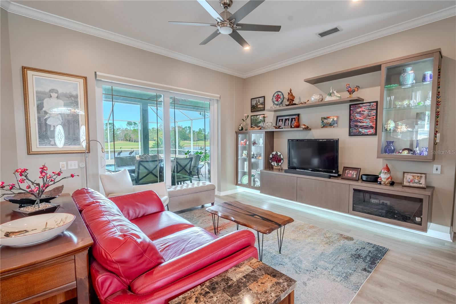 The living room features a built-in wall unit.