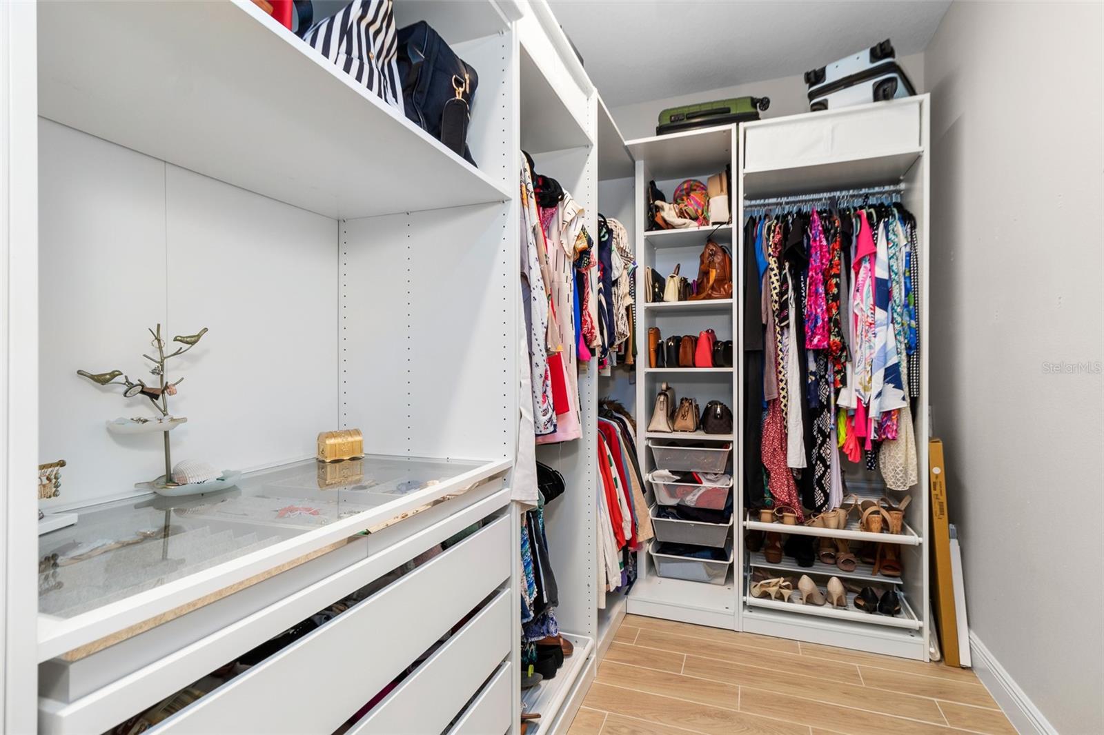 Master Closet custom built in with tons of hanging space and drawer storage