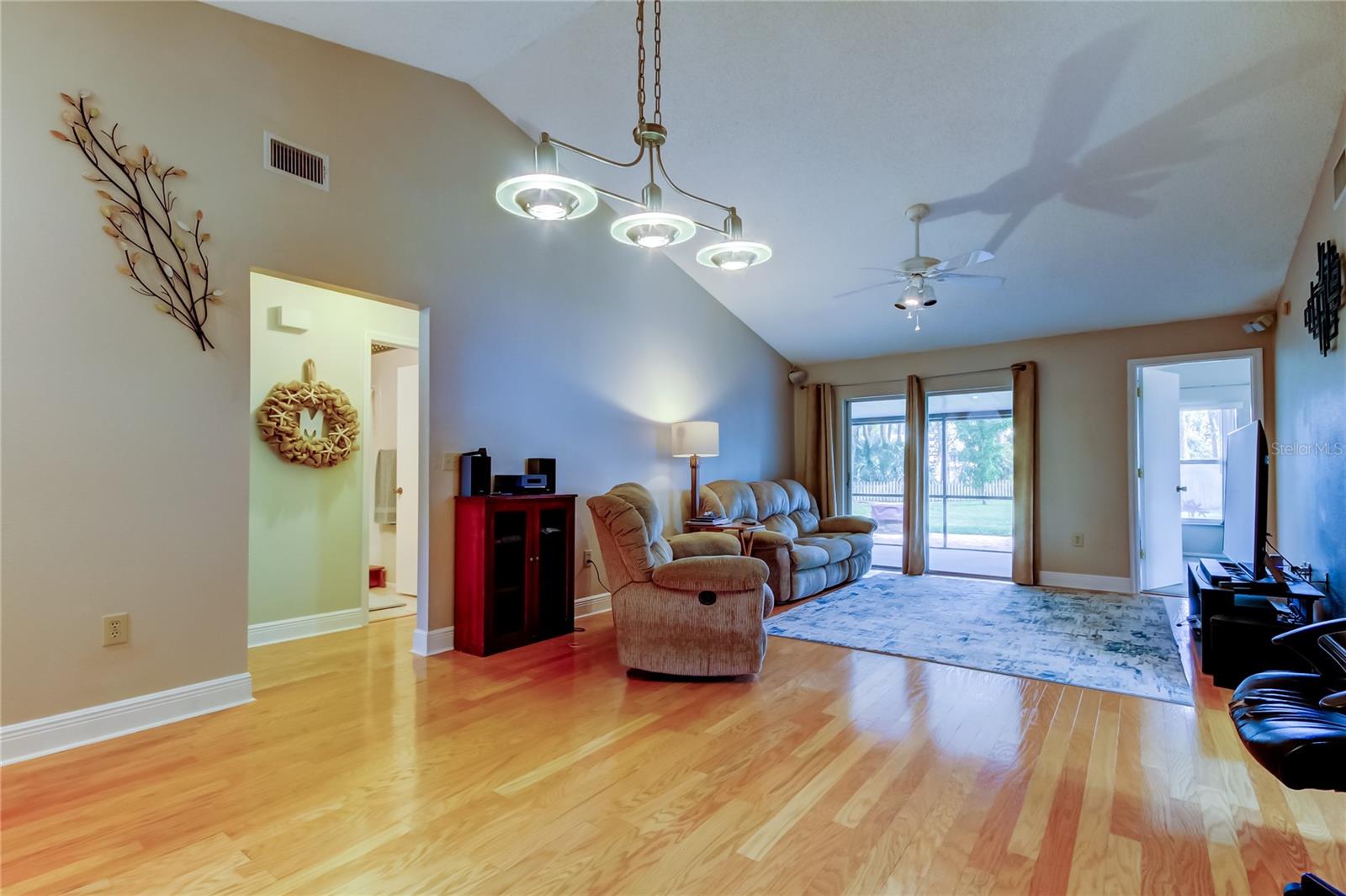 Spacious living/dining area with laminate wood flooring.