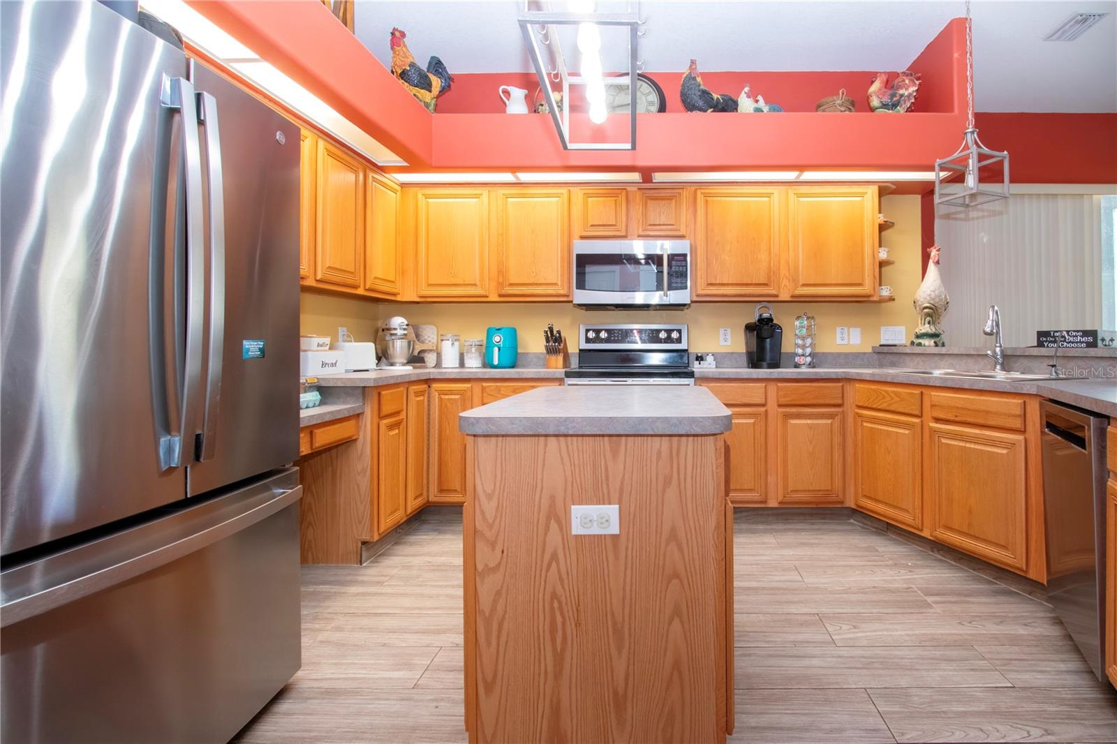 New Stainless Steel Refrigerator and An Abundance Of Kitchen Cabinets