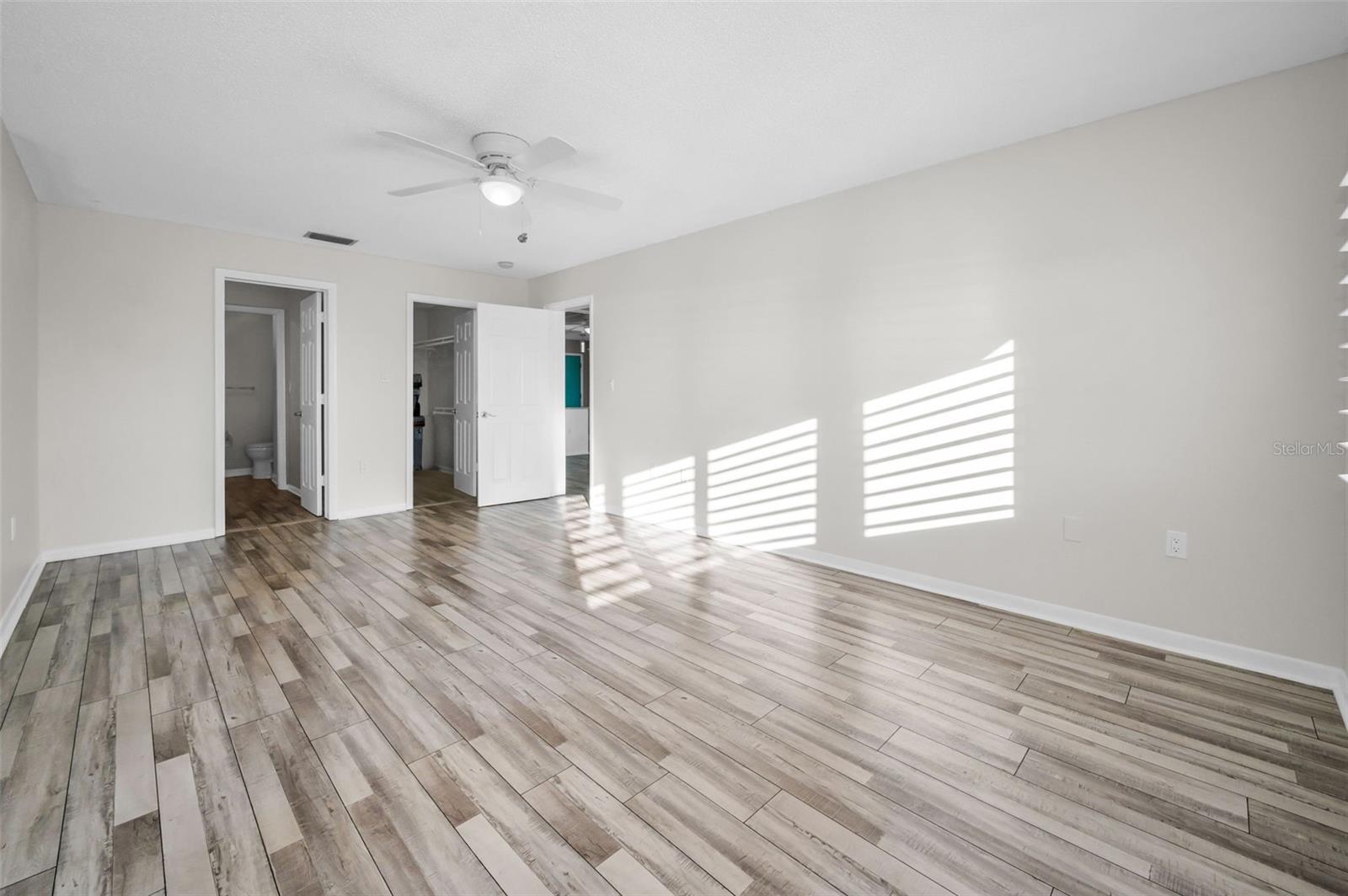 Primary bedroom with walk-in closet and entrance to ensuite