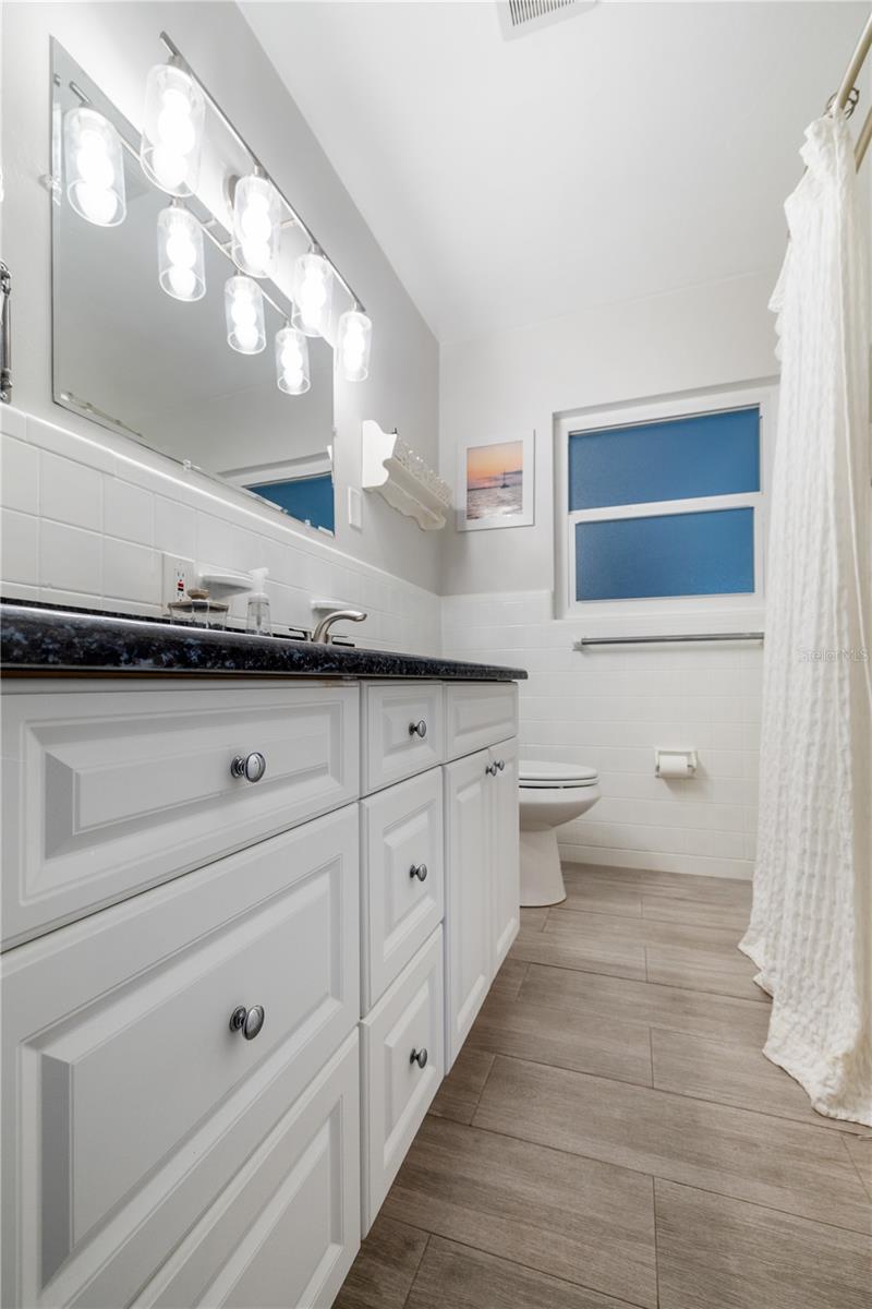 Full guest bathroom with tub