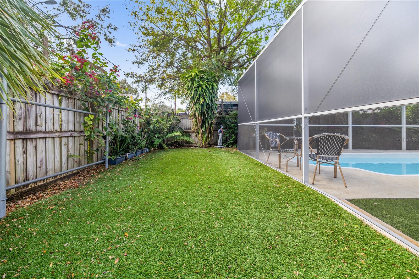 Turfed backyard with privacy fence