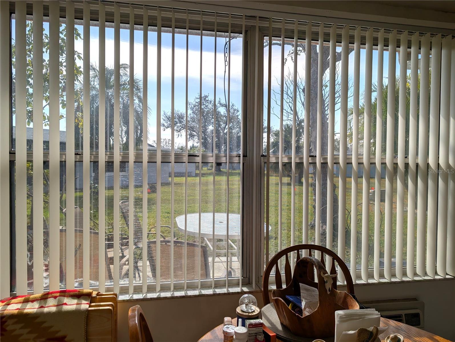 View of patio and open backyard area from Florida Room