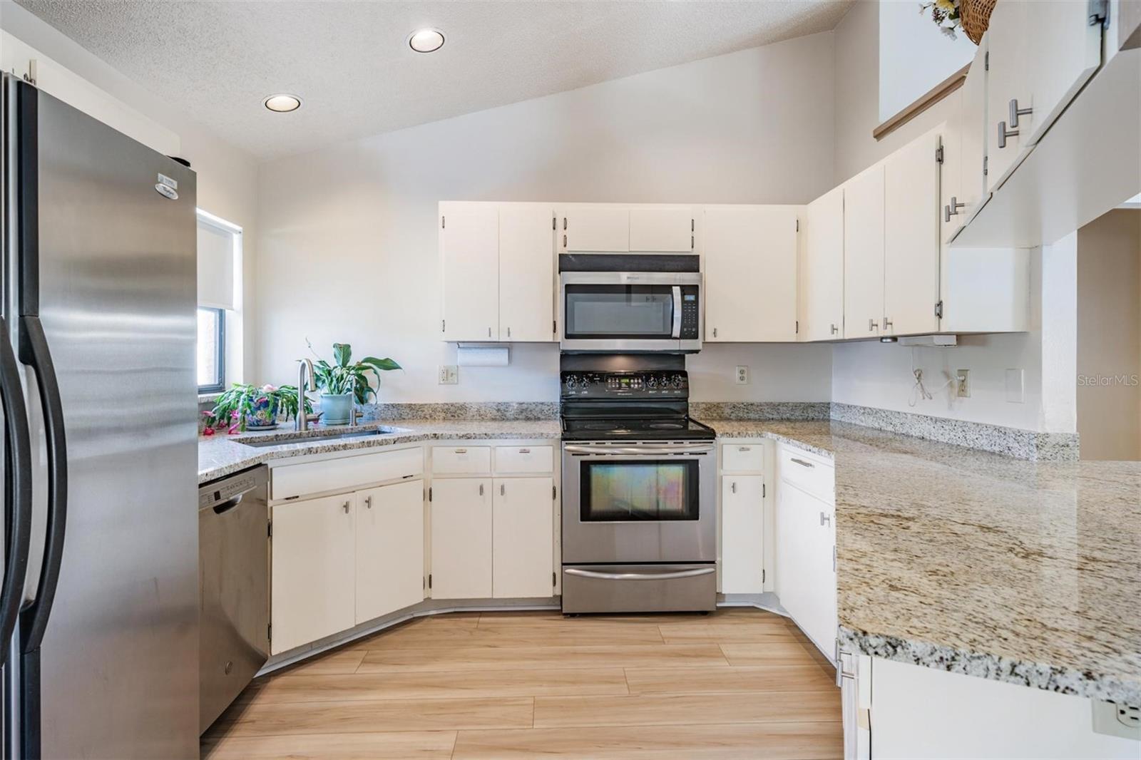 The kitchen features new granite countertops with breakfast bar, a reverse osmosis water system, new sink and fixture, and stainless-steel appliances