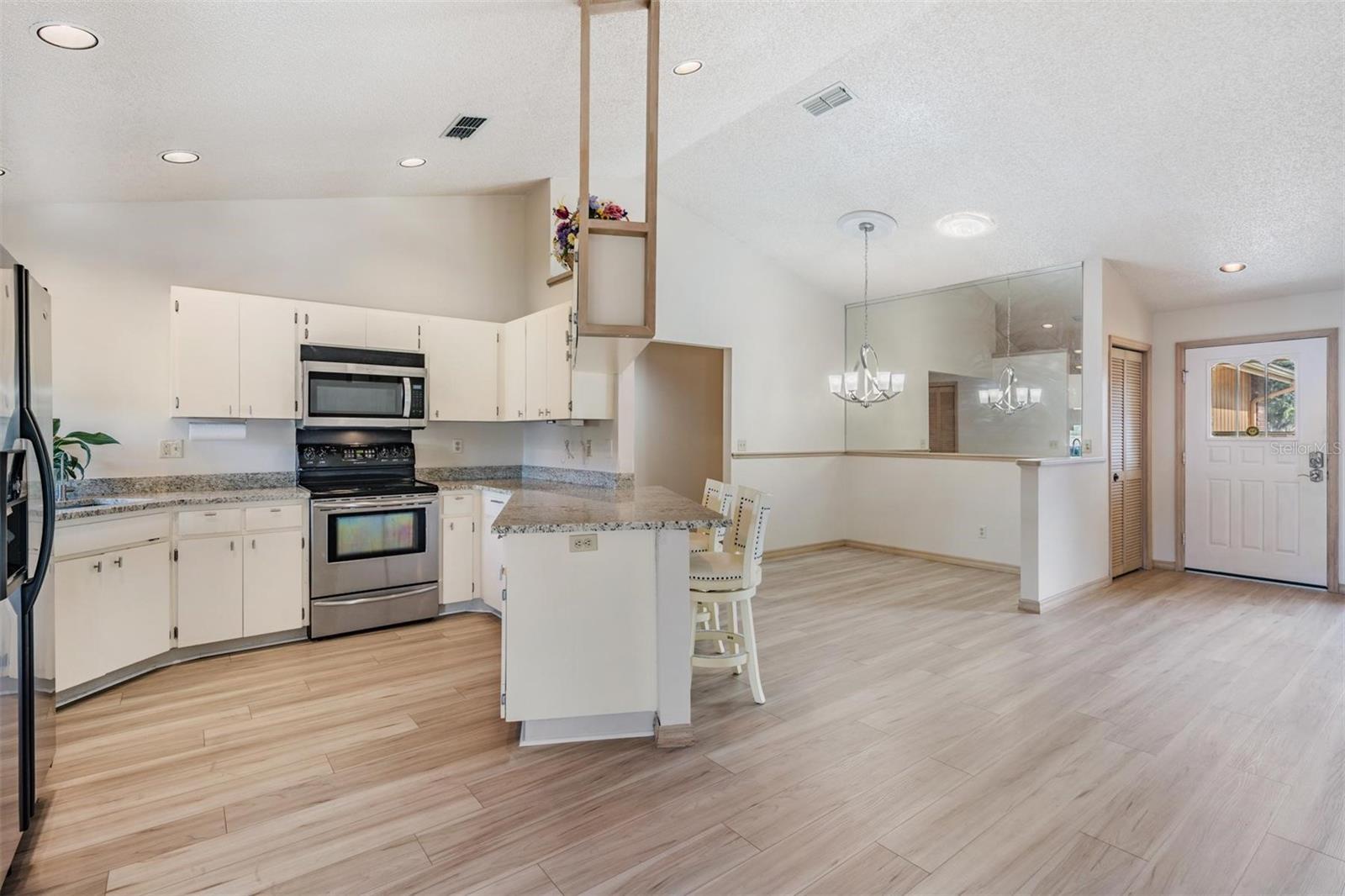 The kitchen features new granite countertops with breakfast bar, a reverse osmosis water system, new sink and fixture, and stainless-steel appliances