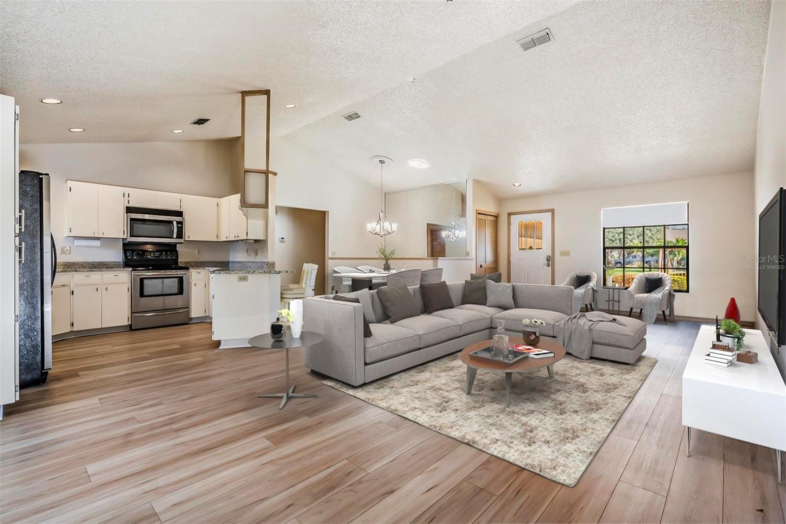 Virtually Staged: Wide-open floor plan with beautiful NEW WATERPROOF LUXURY VINYL FLOORING that flows throughout, fresh interior paint, HIGH CEILINGS, and the amazing kitchen!