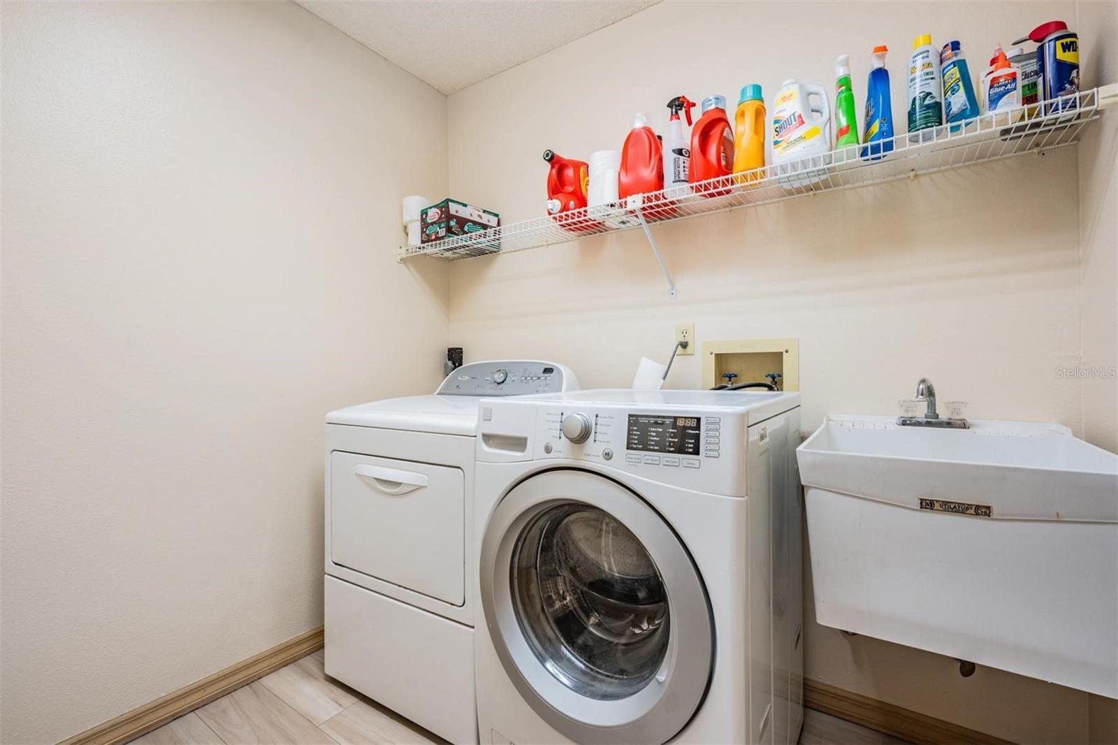 Inside Laundry Room with washer and dryer and utility sink