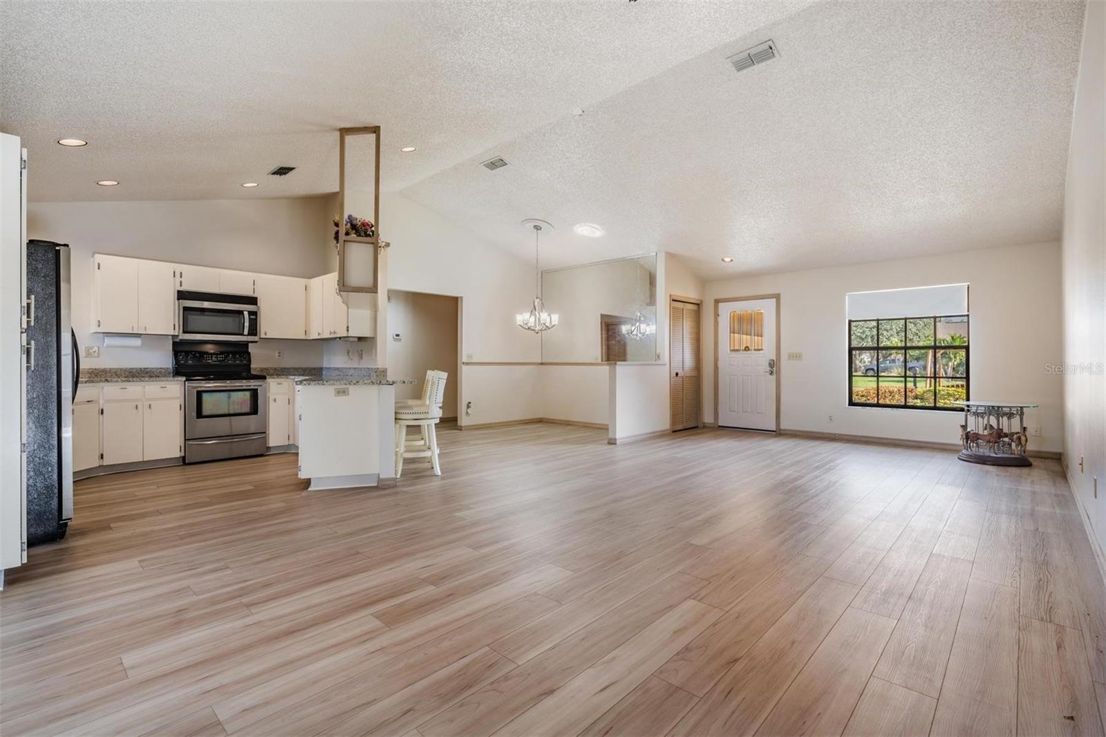 Wide-open floor plan with beautiful NEW WATERPROOF LUXURY VINYL FLOORING that flows throughout, fresh interior paint, HIGH CEILINGS, and the amazing kitchen!