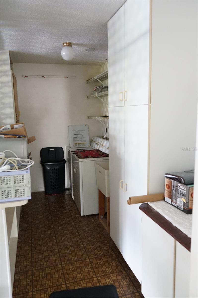 laundry in garage with extra cabinets