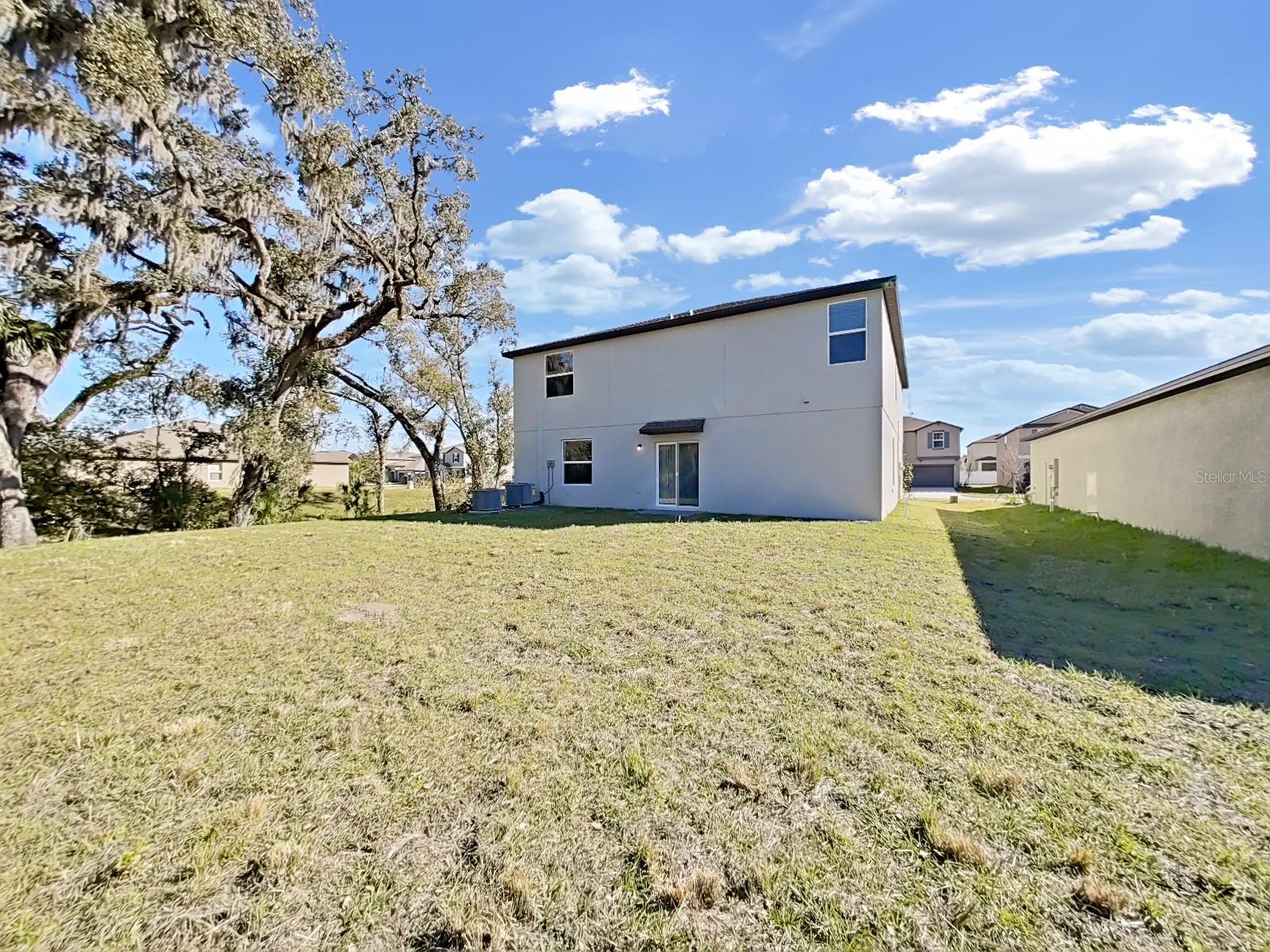 Private backyard with conservation and retention pond besides it.