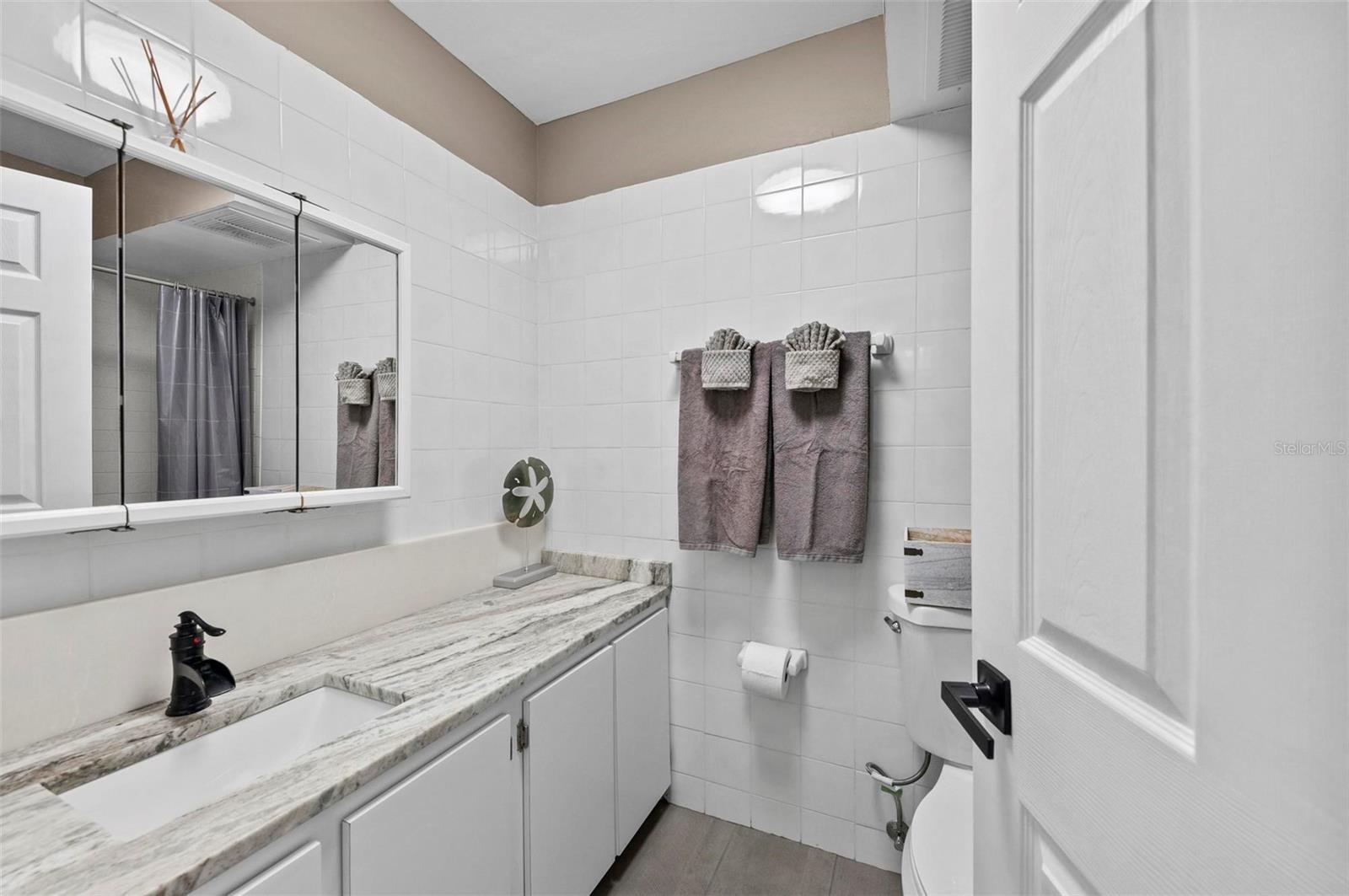 Bathroom 2 with  shower/tub, updated vanity and granite countertops