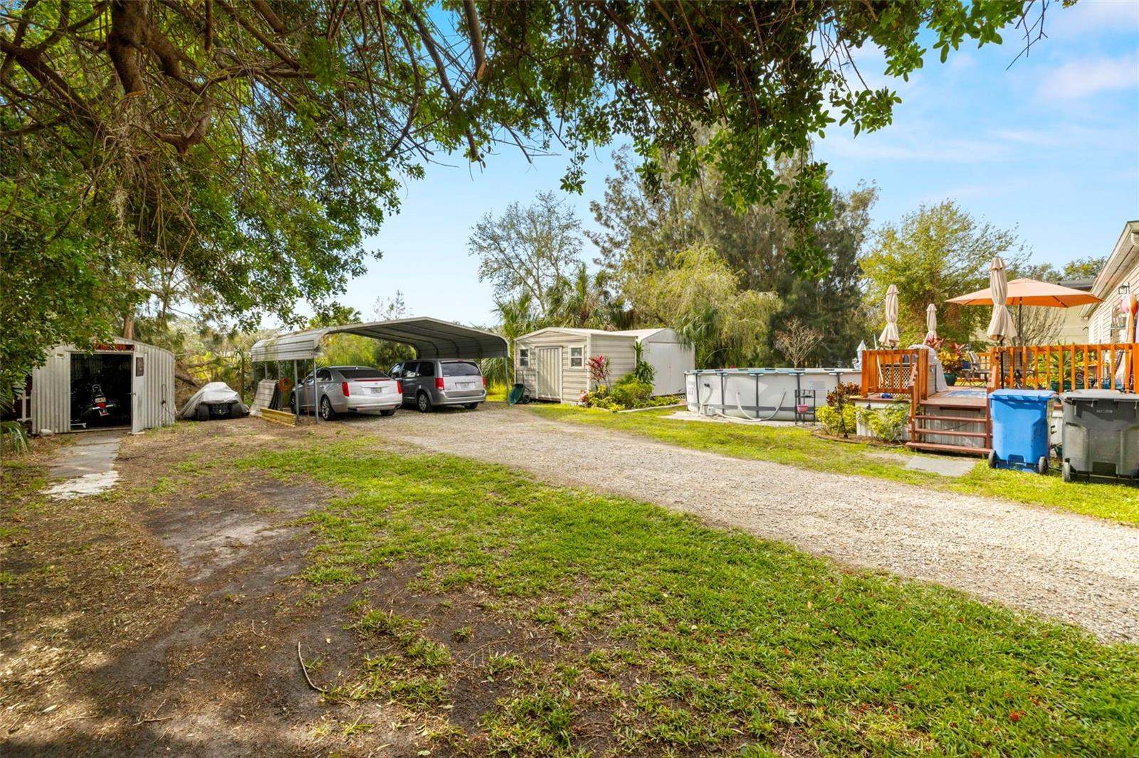 Covered 2 Car Carport, 3 shed buildings with plenty of storage space.