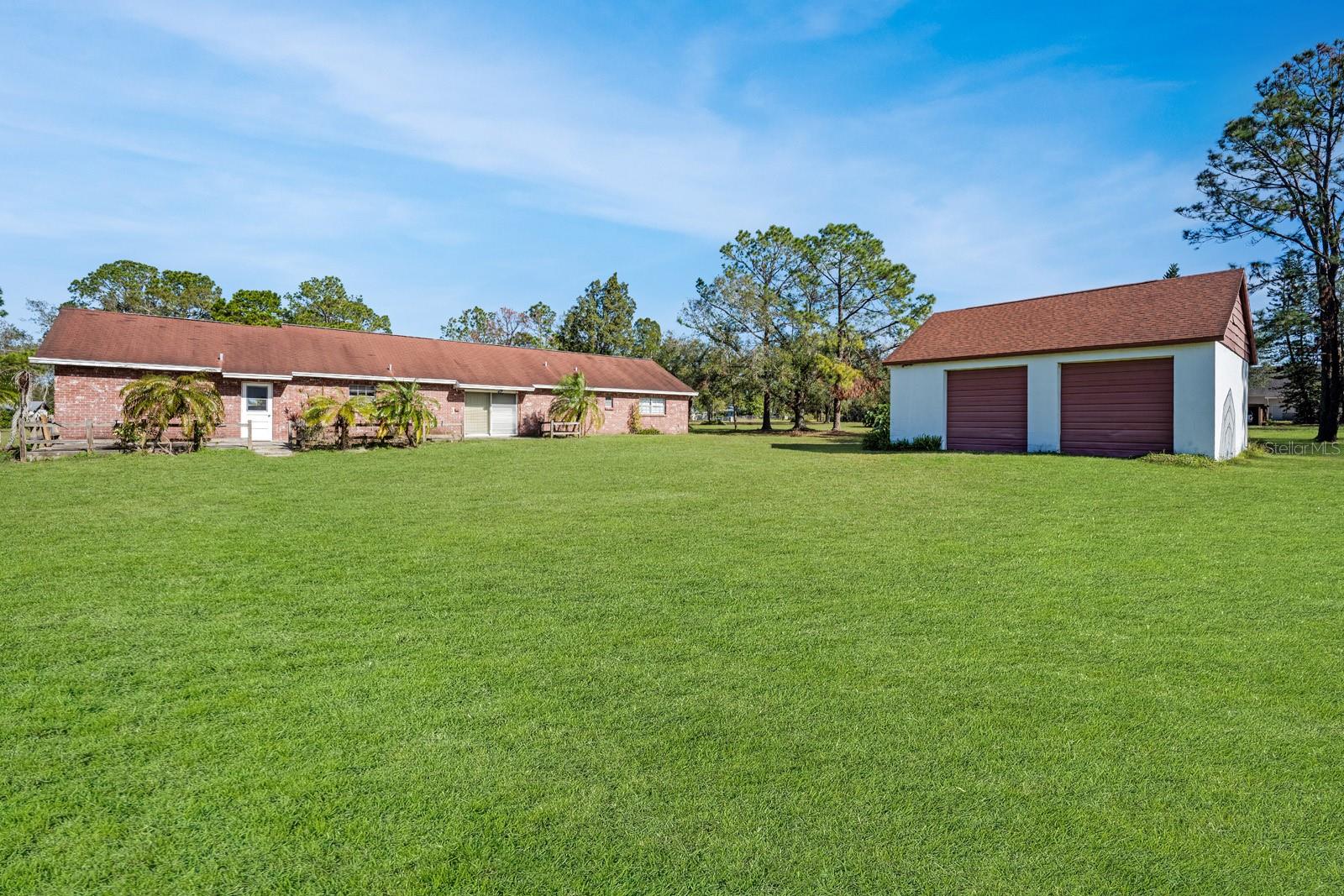 BACK OF HOUSE WITH PIC OF DETACHED GARAGE