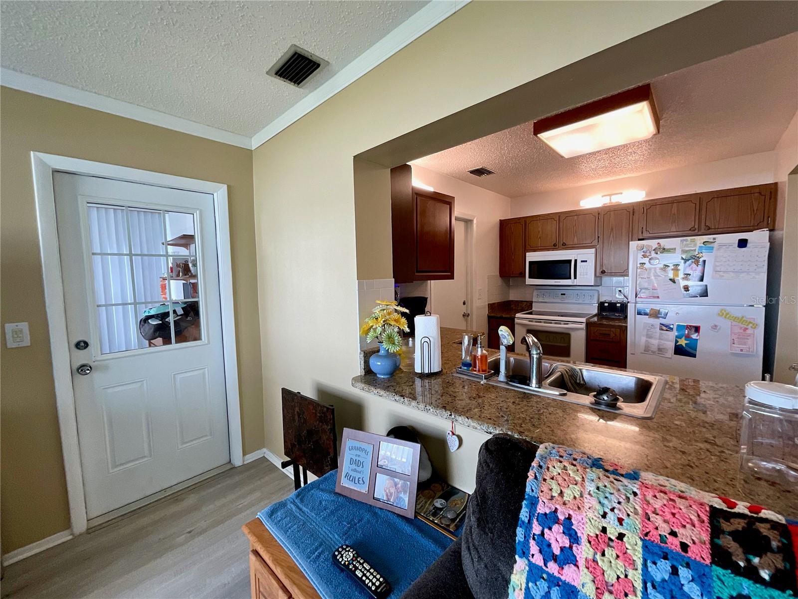 Family room with door to covered screened patio