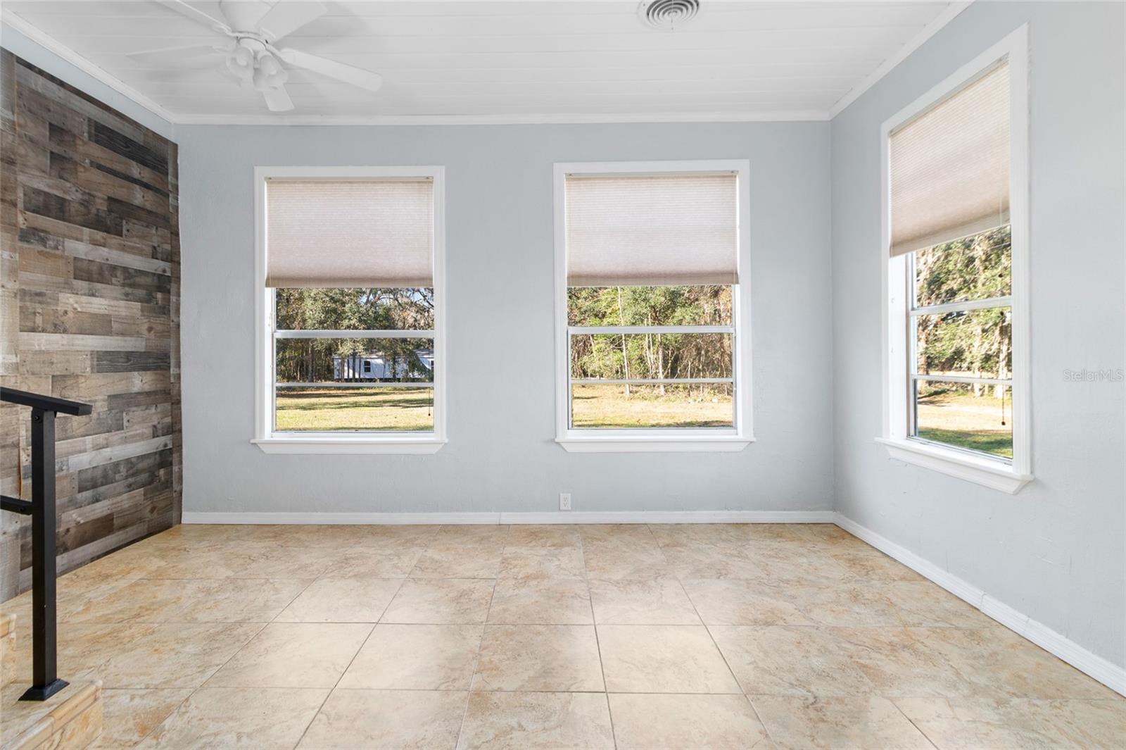 TV Room with tons of windows with natural daylight for an open nature-filled view of the tranquil surroundings