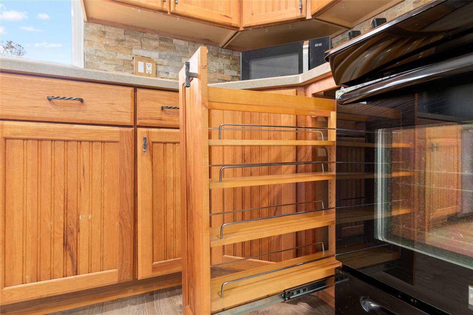 This kitchen is lovely. It has custom wood cabinetry and solid surface countertops with a lovely view of the yard.