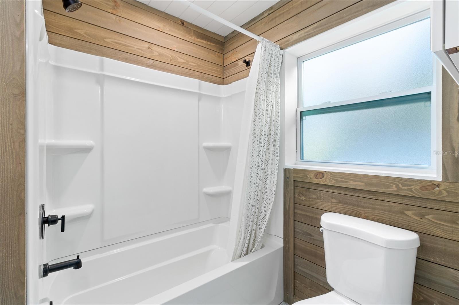 Guest Bathroom in the center of the home with a tub/shower