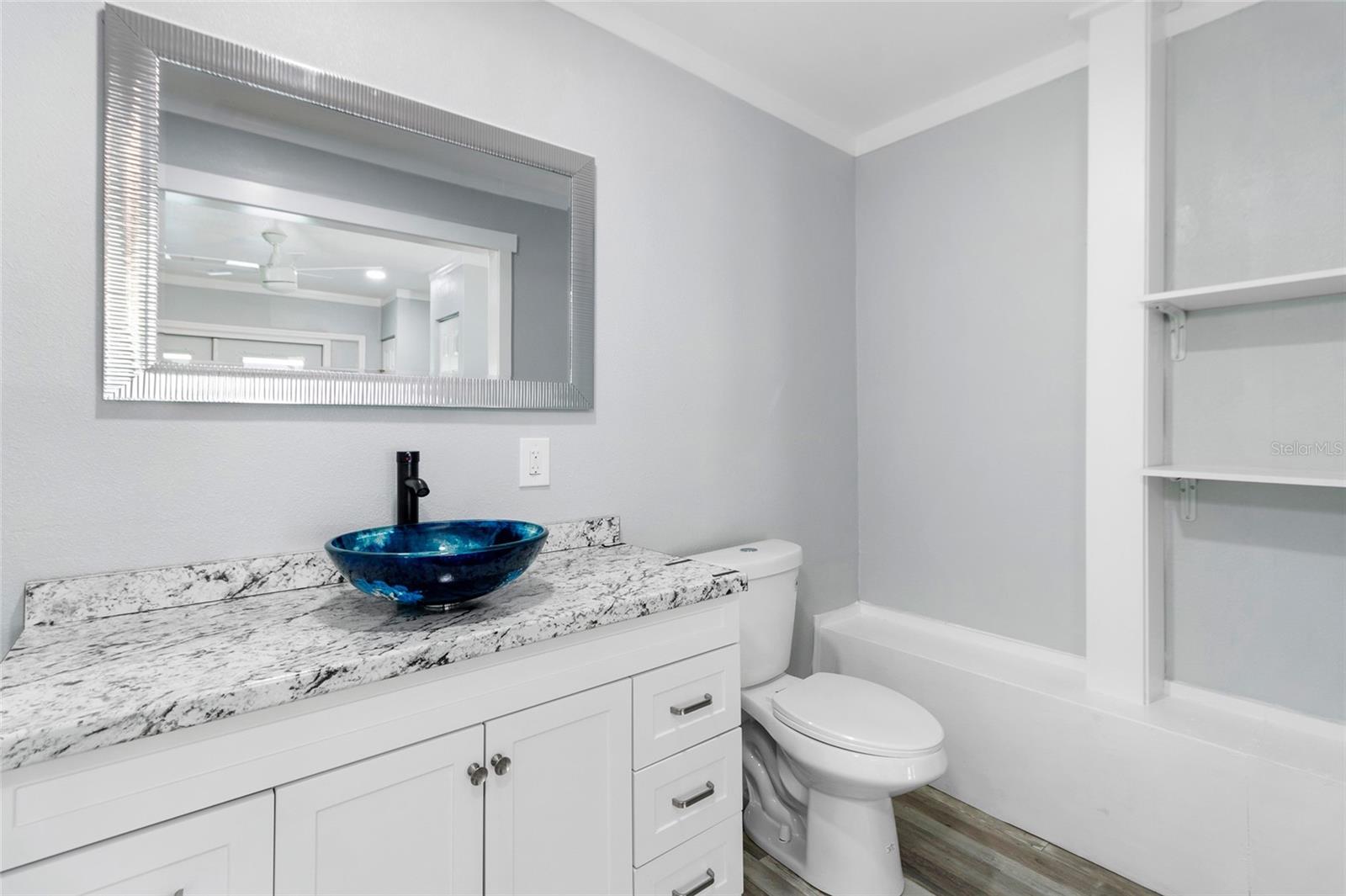 This is the primary full bathroom. It has a beautiful barndoor for privacy.