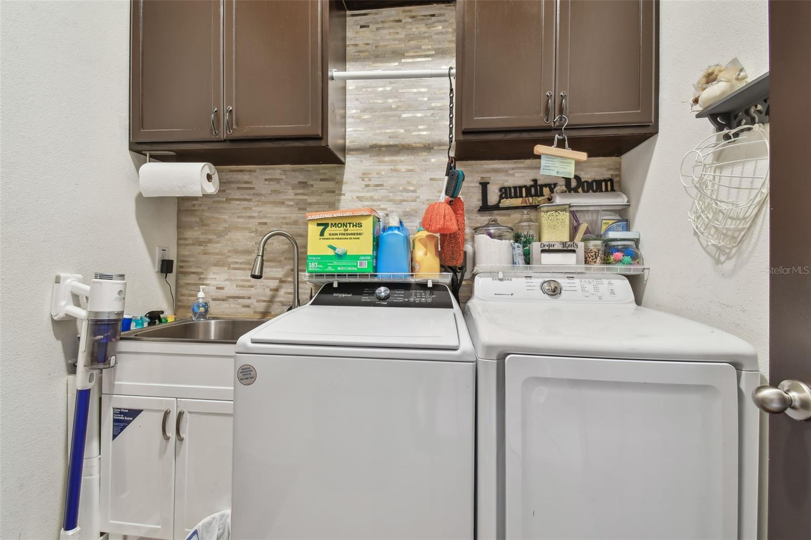 Washer and Dryer located in space before door to garage