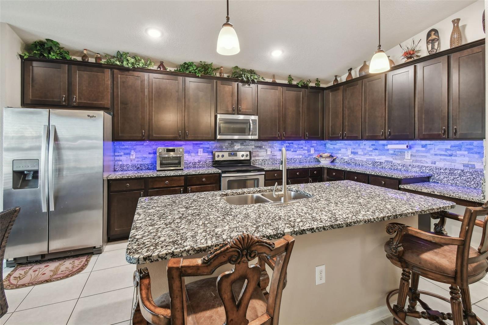 LED Lighting below kitchen cabinets and stainless steel appliances throughout.