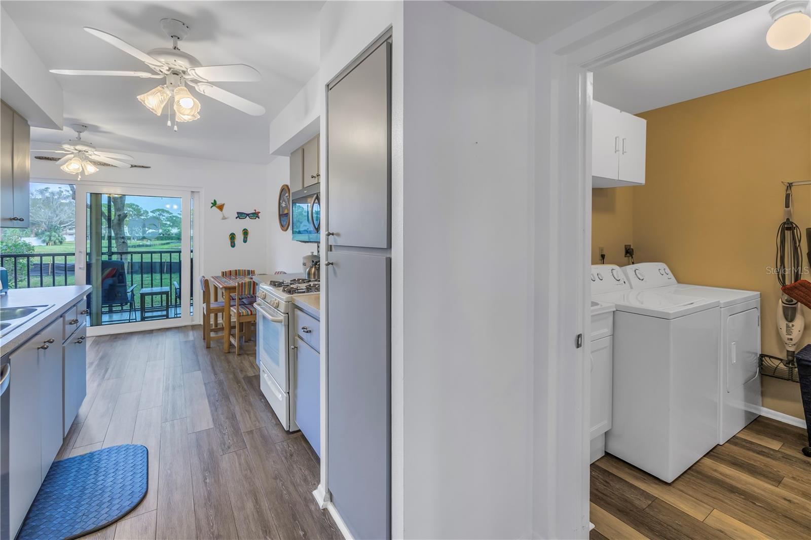 Kitchen with adjacent laundry/storage room.