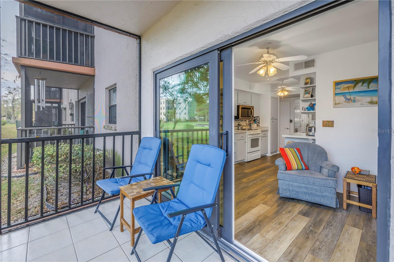 A covered, screened lanai that showcases peaceful pond views.